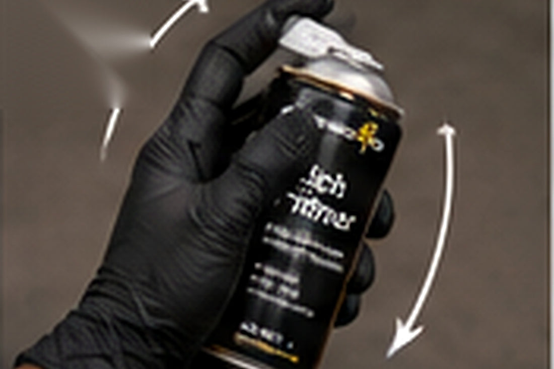Shaking an aerosol primer and checking the spray pattern on a test card