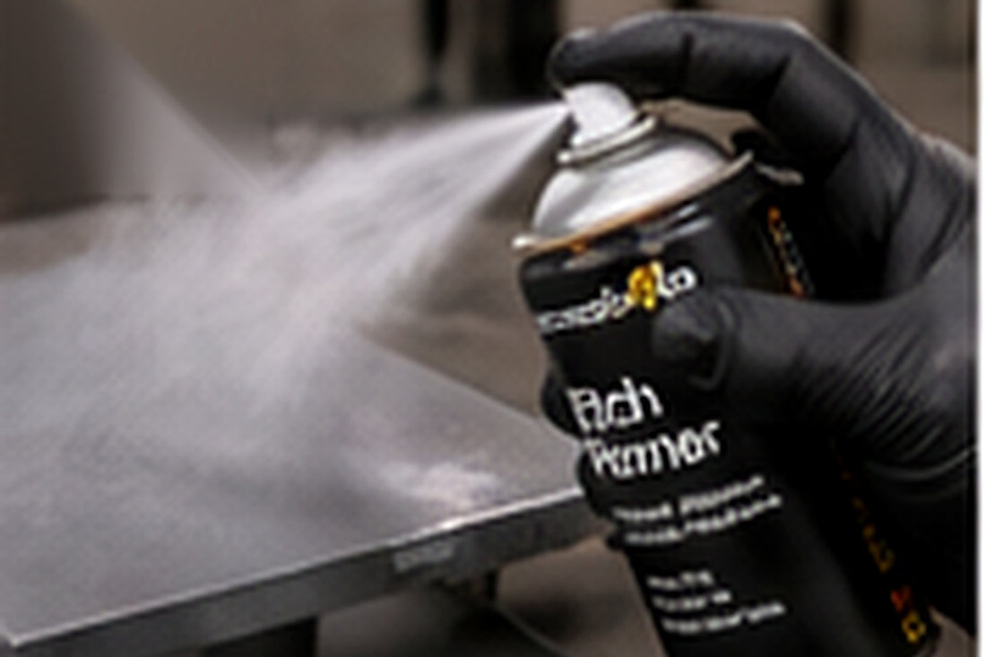 Applying the first light coat of aerosol primer to a panel