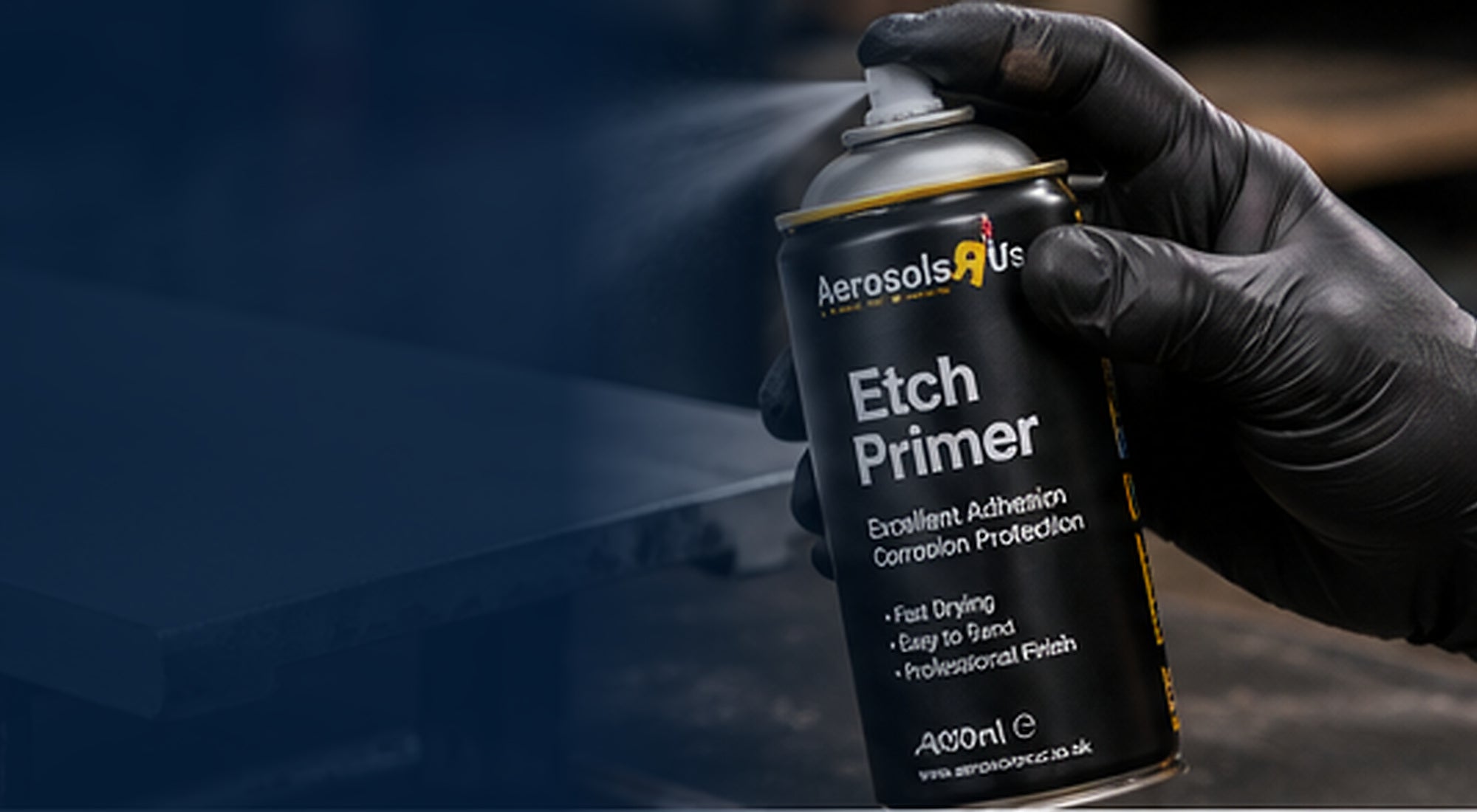 Applying aerosol primer in light even coats to a prepared metal panel